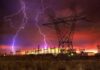 Data Center Pause Shocks Wall Street Lightning strikes illuminate a power station against a colorful sunset sky