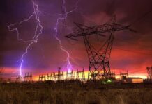 Data Center Pause Shocks Wall Street Lightning strikes illuminate a power station against a colorful sunset sky