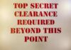 Gates’ Nuclear Clearance Bombshell Sign with red stenciled letters on a beige background