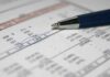 Medicare Math Games Exposed Close-up of a financial document with highlighted numbers and a pen