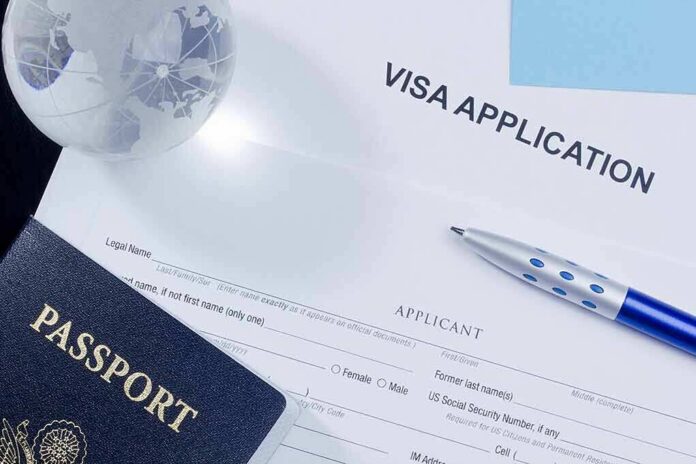 shutterstock_111455090 Visa application form with passport and pen