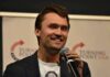 Charlie Kirk Cornered Hasan Piker— On Camera man speaking into a microphone on stage