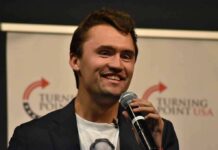Charlie Kirk Cornered Hasan Piker— On Camera man speaking into a microphone on stage