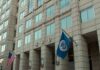 Assassination Plot Twist: U.S. Defies Court U.S. government building facade with American and blue departmental flags