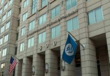 Assassination Plot Twist: U.S. Defies Court U.S. government building facade with American and blue departmental flags