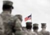 $30K Bounty Put On U.S. Troops American flag above blurred soldiers in formation