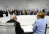delegates seated around a large round conference table