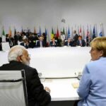 delegates seated around a large round conference table