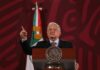 Cartel-Tied Governor Back In Power speaker at a podium gesturing with one finger raised