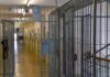 Prison corridor with barred doors