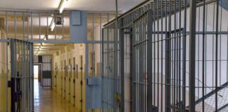 Prison corridor with barred doors