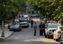 Assassination Claim Shocks Israel—Which Son? Police officers secure a residential street with patrol cars and yellow tape