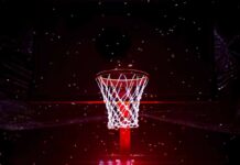Basketball hoop glowing under red spotlight