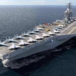 Aircraft carrier at sea with fighter jets on deck