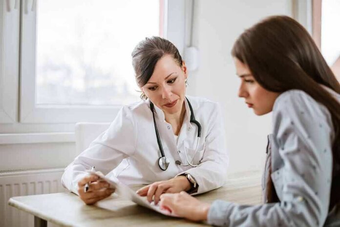 shutterstock_796803439-1 Doctor consulting a patient at a desk