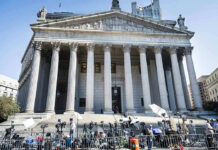 Kremlin-Linked Kill Plot Inside America Courthouse facade with media crews setting up outside.