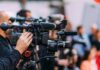 Holdout Juror Derails High-Profile Murder Trial Video cameras on tripods at a media event