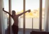 Sex Sells Sports? WNBA Star Calls B.S. Woman stretching with coffee by a balcony window at sunrise