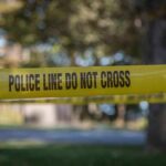 yellow police tape cordoning off an outdoor area