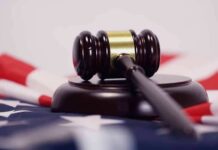 Courthouse Meltdown: Loaded Mag Hidden In Underwear? Judge’s gavel on a base over an American flag