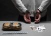 DOJ Drops Wild Election Conspiracy Case person in handcuffs behind back over table with seized packages