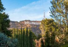 Hollywood Mega-Merger Inches Closer Hollywood Sign on hillside framed by trees