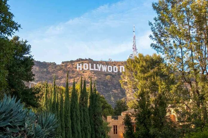 shutterstock_1164563563 Hollywood Sign on hillside framed by trees
