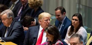 Donald Trump seated between António Guterres and Nikki Haley, with Mike Pompeo in the foreground at a meeting