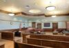Prosecutors Push For Execution Empty courtroom with wooden benches and judge's bench