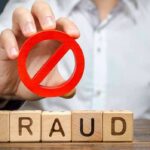 Illegal Financier Snared – Travis Kelce Among Victims Person holding red prohibition symbol over wooden blocks spelling fraud