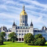 Connecticut State Capitol building with a golden dome and surrounding greenery