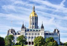 Connecticut State Capitol building with a golden dome and surrounding greenery