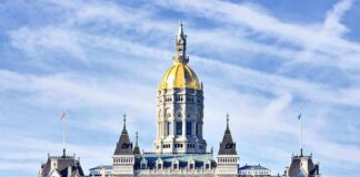 Connecticut State Capitol building with a golden dome and surrounding greenery