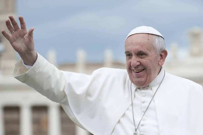 shutterstock_163361345 elderly man in white religious attire waving outdoors