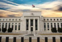 Tariff Hammer Poised — Fed On Notice Neoclassical government building with American flag at sunset