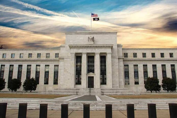 Neoclassical government building with American flag at sunset