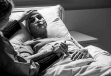 Early Alzheimer’s? One Vial Changes Everything Patient in hospital bed with nasal oxygen held by visitor