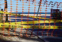 Intruder Scare At Kamala Harris’ Malibu Home Orange safety net and yellow police tape blocking a beach access