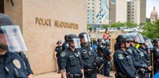 Teddy Williams and Carlos Hyde among police officers in riot gear outside police headquarters