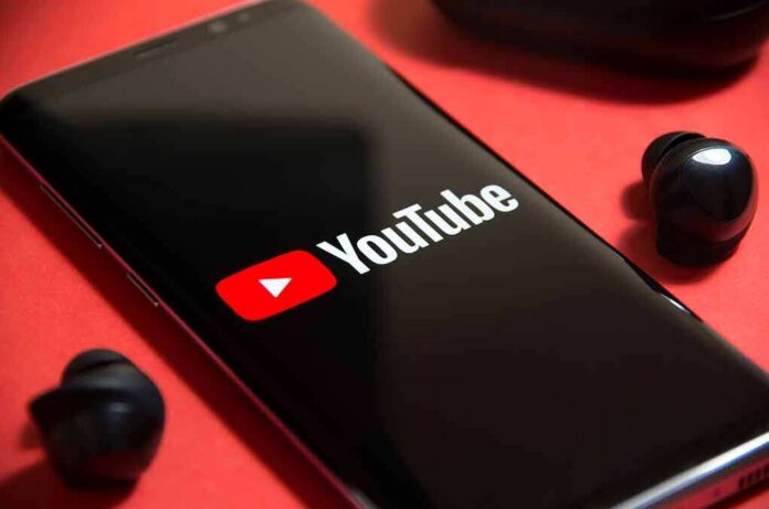 smartphone displaying YouTube logo on red background