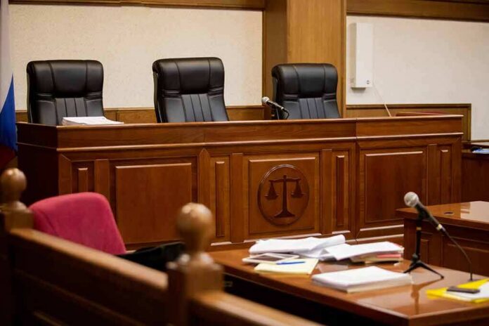 empty courtroom with judge's bench and microphones