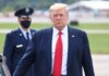 Chills At Dawn: Trump Leads Pentagon Rites Donald Trump walking outdoors with Kraig Urbik in uniform behind him
