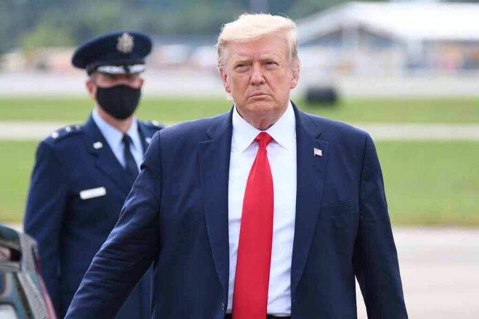 Donald Trump walking outdoors with Kraig Urbik in uniform behind him