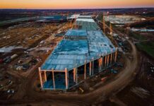 aerial view of large industrial building under construction at sunset