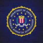 FBI seal painted on a dark brick wall