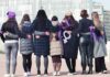 Sorority Power Play Stuns Courts Group of women standing arm in arm with purple ribbons