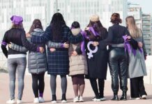Sorority Power Play Stuns Courts Group of women standing arm in arm with purple ribbons