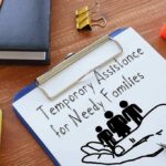 Clipboard with TANF form and family icon on desk