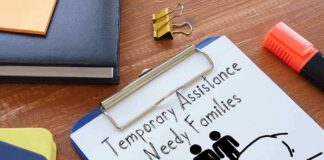 Clipboard with TANF form and family icon on desk