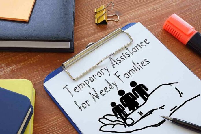shutterstock_2138829551 Clipboard with TANF form and family icon on desk